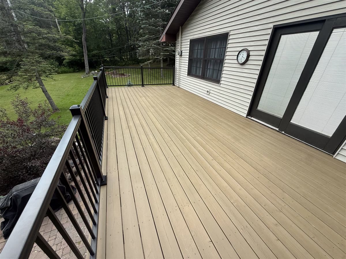 Professional deck staining and sealing on a backyard deck