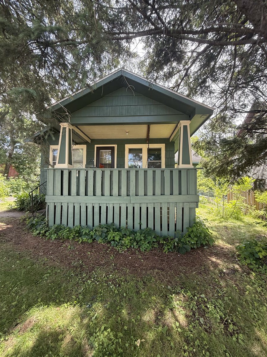 Completed sage green exterior painting on a bungalow by The Painting Company
