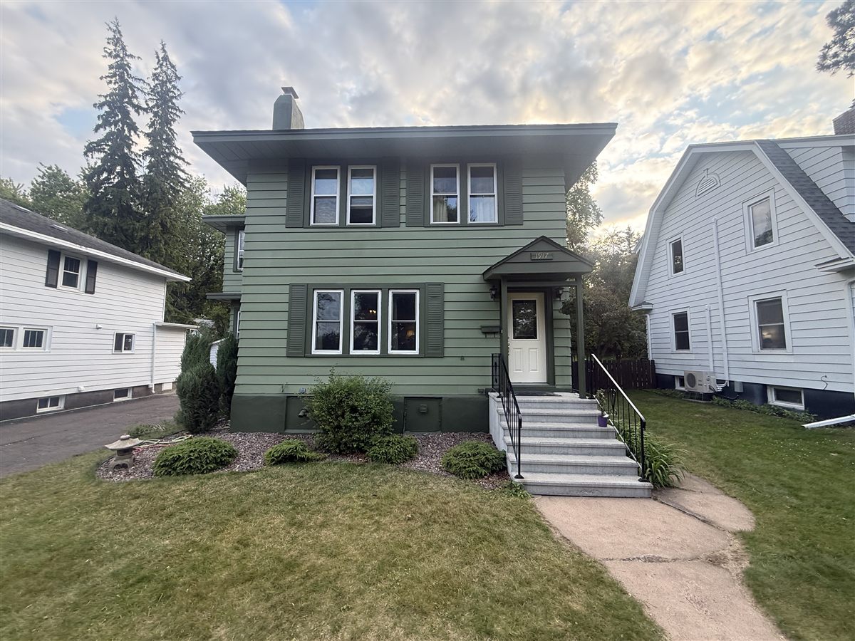 Sage green exterior with dark green trim on a two-story home